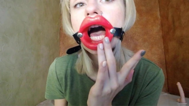 Zooming in red lips open mouth gag for dildo-blowjob.